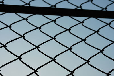 Full frame shot of chainlink fence against sky