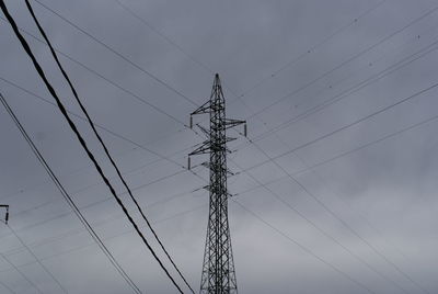 Low angle view of electricity pylon against sky