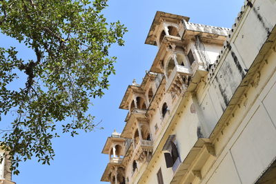 Low angle view of udaipur city palace against clear sky