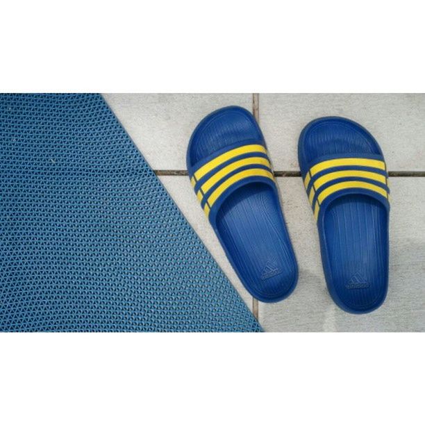 transfer print, auto post production filter, blue, indoors, multi colored, yellow, shoe, low section, high angle view, flooring, close-up, still life, tiled floor, day, person, pattern, no people, colorful, footwear, shadow