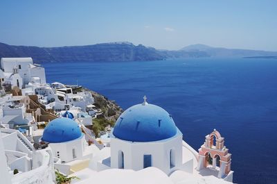 Panoramic view of sea and buildings against sky