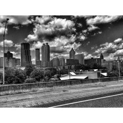 Buildings against cloudy sky