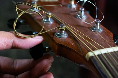 Midsection of person playing guitar