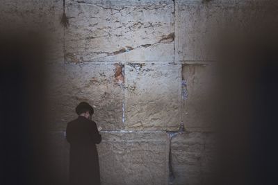 Rear view of man praying wailing wall