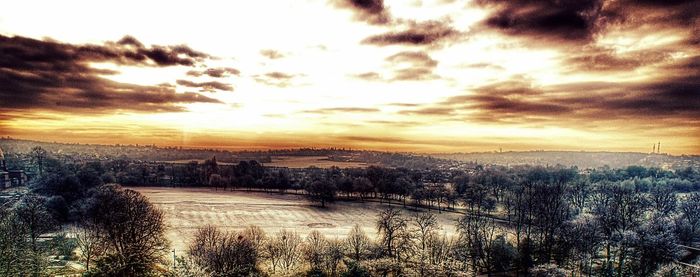 Scenic view of river against sky at sunset