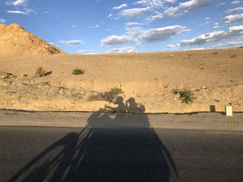 Shadow of man on desert road