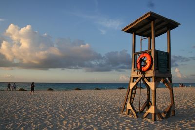 Lifeguard hut on beach against sky