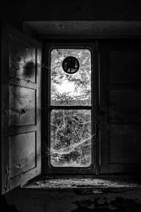 Close-up of window on abandoned door