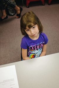 Portrait of girl sitting at table