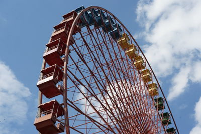 Low angle view of ferris wheel against sky