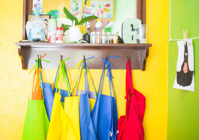 Multi colored bottles hanging on shelf at home