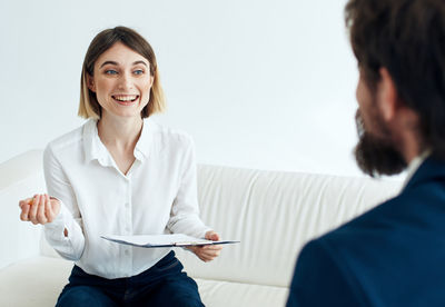 Side view of female doctor examining patient in clinic