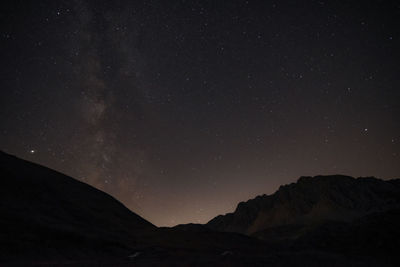 Scenic view of mountains against sky at night