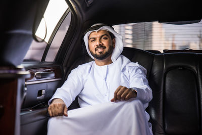 Full length of man sitting in car