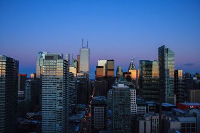 High angle shot of cityscape against blue sky