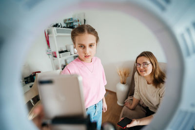 Mother and daughter record video use smartphone