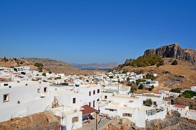 Town against clear blue sky