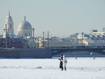 View of buildings against clear sky during winter