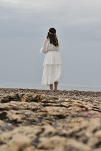 Woman looking from behind on the beach