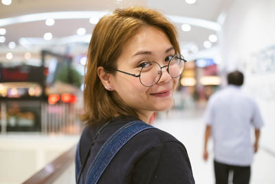 Portrait of smiling young woman at airport