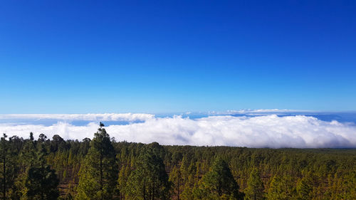 Panoramic shot of land against blue sky