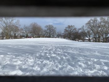 Snow covered field against sky