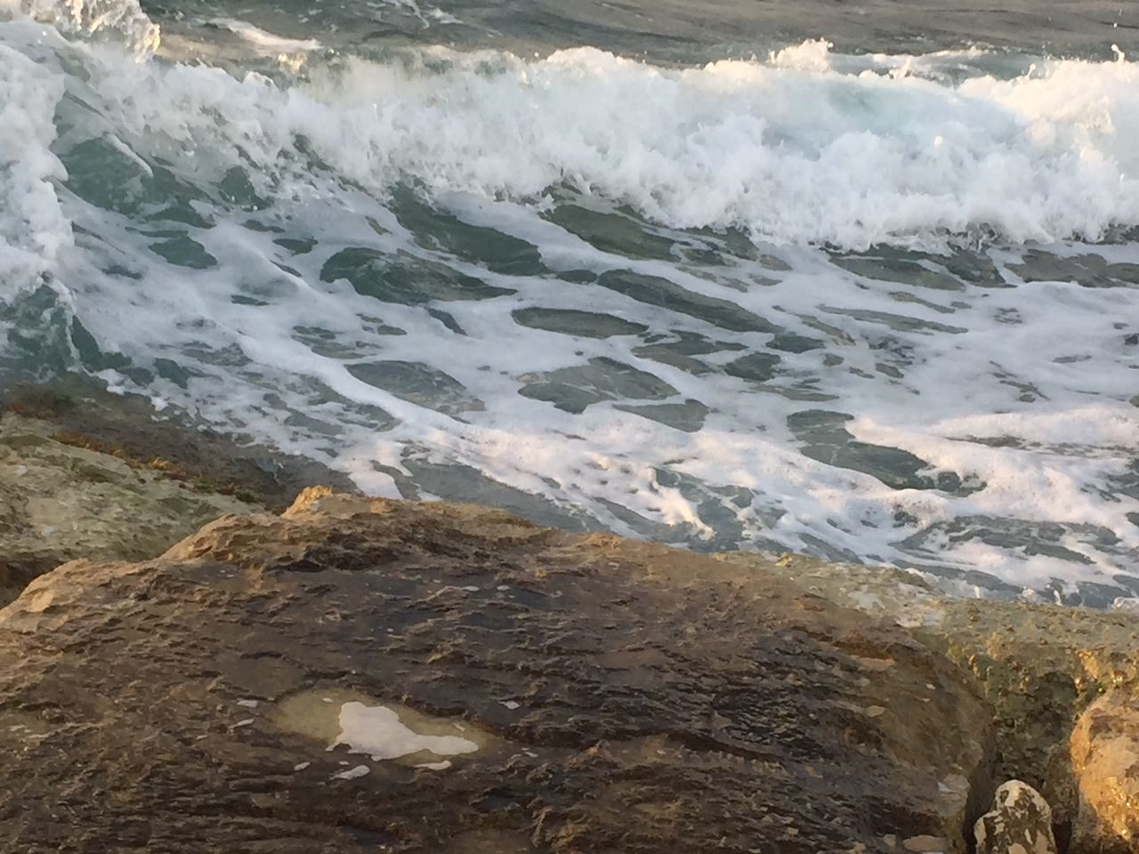 water, surf, beauty in nature, scenics, wave, nature, motion, sea, rock - object, high angle view, tranquility, tranquil scene, power in nature, shore, splashing, winter, cold temperature, day, outdoors, idyllic