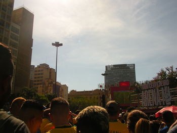 People on street against buildings in city