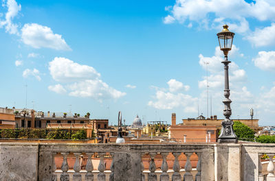 View of buildings from terrace against cloudy sky