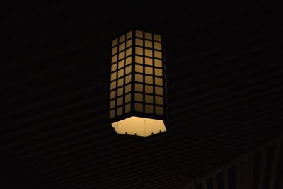 Low angle view of illuminated lamp on building