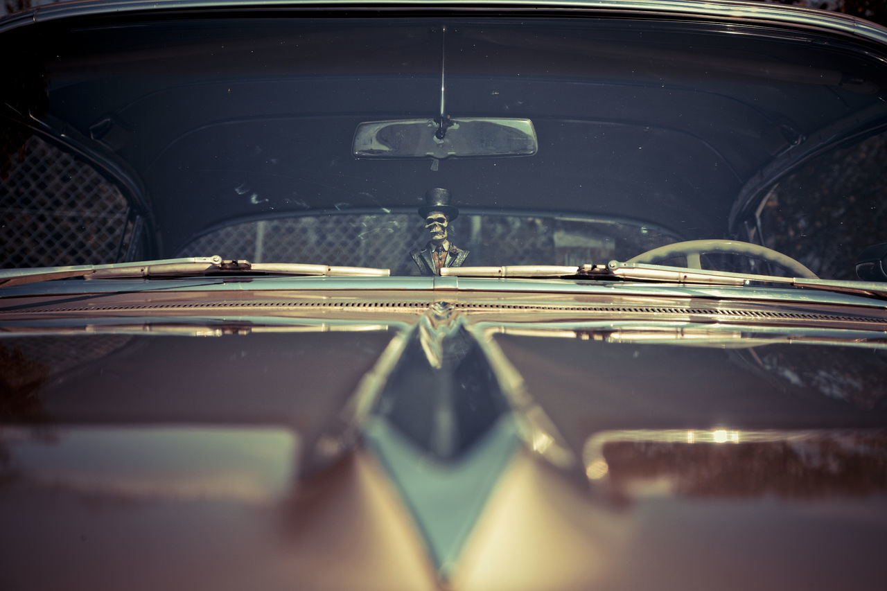 CLOSE-UP OF CAR ON ROAD