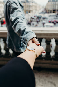 Midsection of woman holding hands with a man in paris