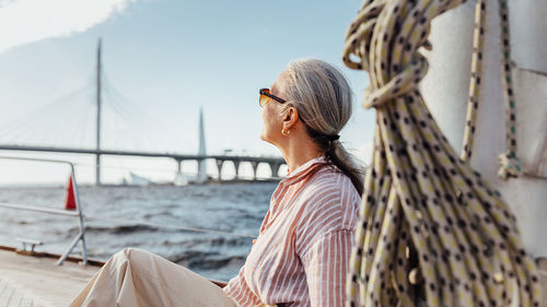 Side view of woman wearing sunglasses outdoors