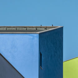 Low angle view of building against clear blue sky