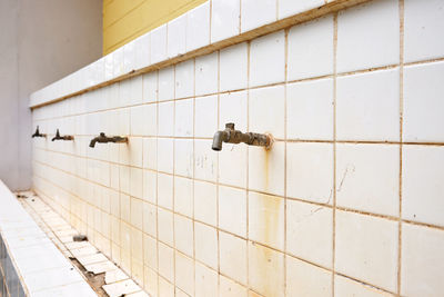 Close-up of pipes on tiled floor