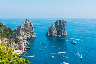 High angle view of rocks in sea against sky