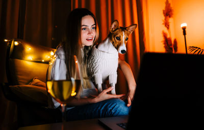 Portrait of smiling young woman sitting at home