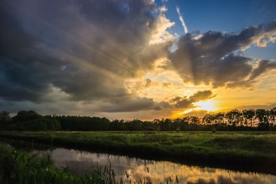 Scenic view of field against sky during sunset