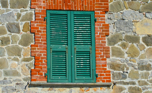 Closed window on brick wall of building