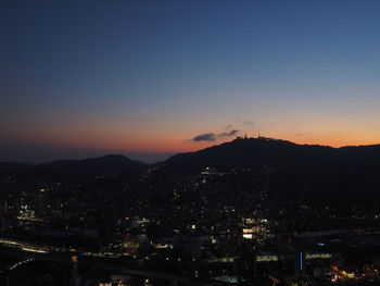 High angle view of illuminated buildings against sky at sunset