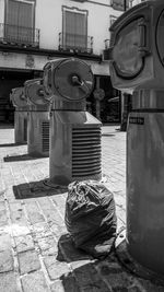 Garbage bin on street in city