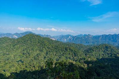 Scenic view of mountains against blue sky