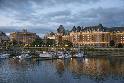 Boats in river with buildings in background