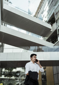 Young man looking through glass window