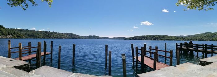 Pier on lake against blue sky
