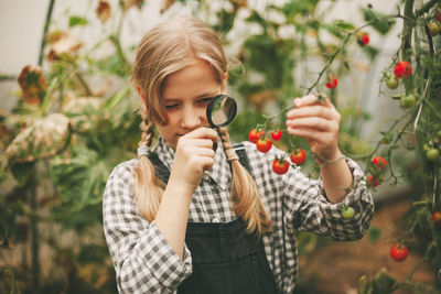 Close-up of girl holding plants