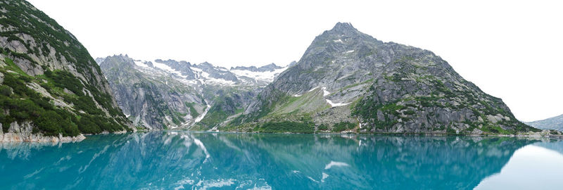 Scenic view of lake and mountains against clear sky