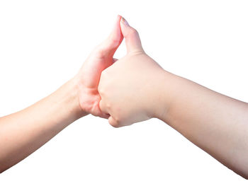 Close-up of hands against white background