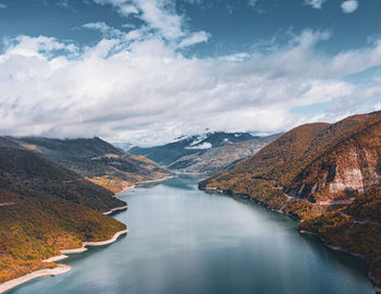 Scenic view of lake amidst mountains against sky