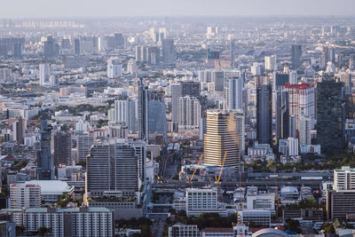 Aerial view of modern buildings in city against sky